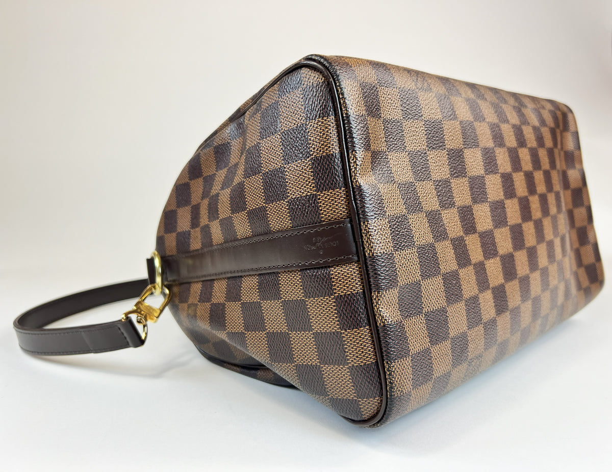 Excellent Pre-Loved Dark Brown Checker Patterned Coated Canvas Top Handle Bowling Bag with Top Zip and Dark Brown Leather Accents. (corner)