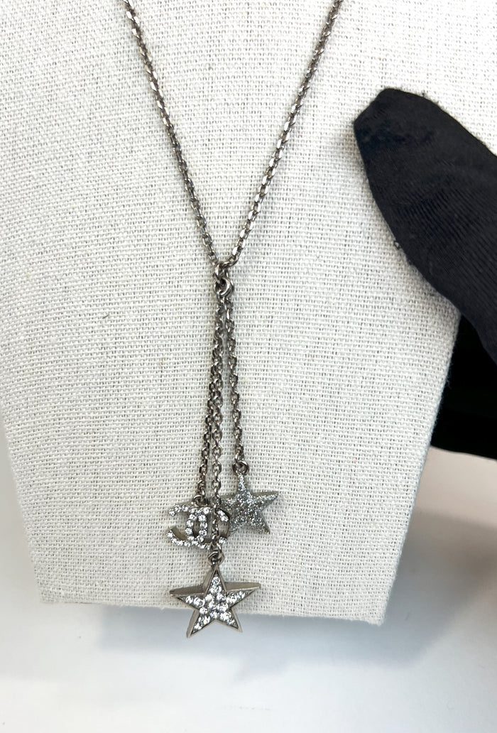 Excellent Pre-Loved Silver Toned Crystal Embellished 2 Star Motif and Logo Pendant Drop Necklace.  (closeup)