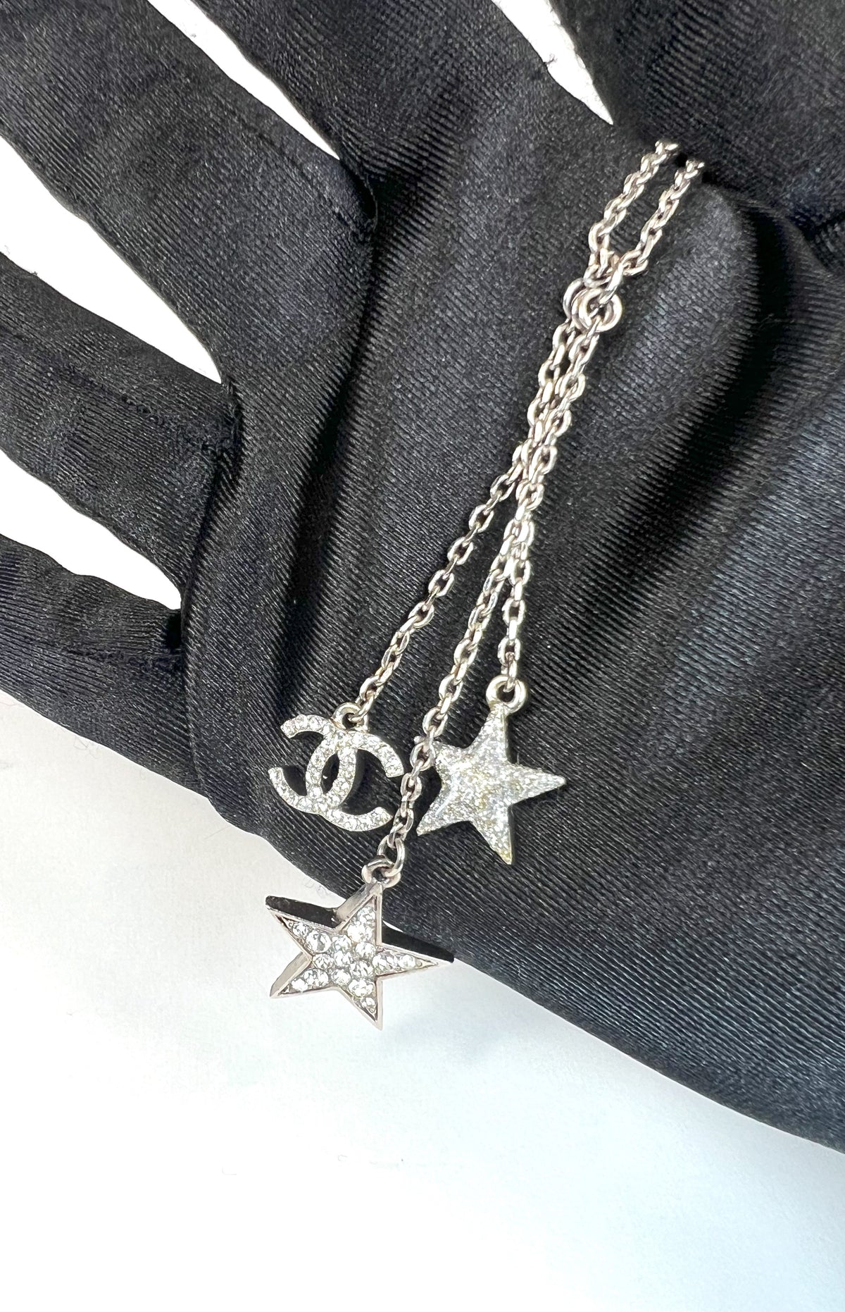 Excellent Pre-Loved Silver Toned Crystal Embellished 2 Star Motif and Logo Pendant Drop Necklace.  (close up)