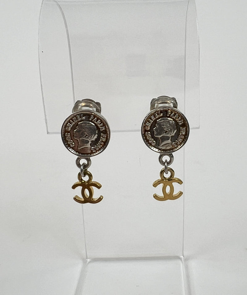 Excellent Pre-Loved Silver Tone Coin Shape Clip On Earrings with Gold Tone Logo Drop. (front)