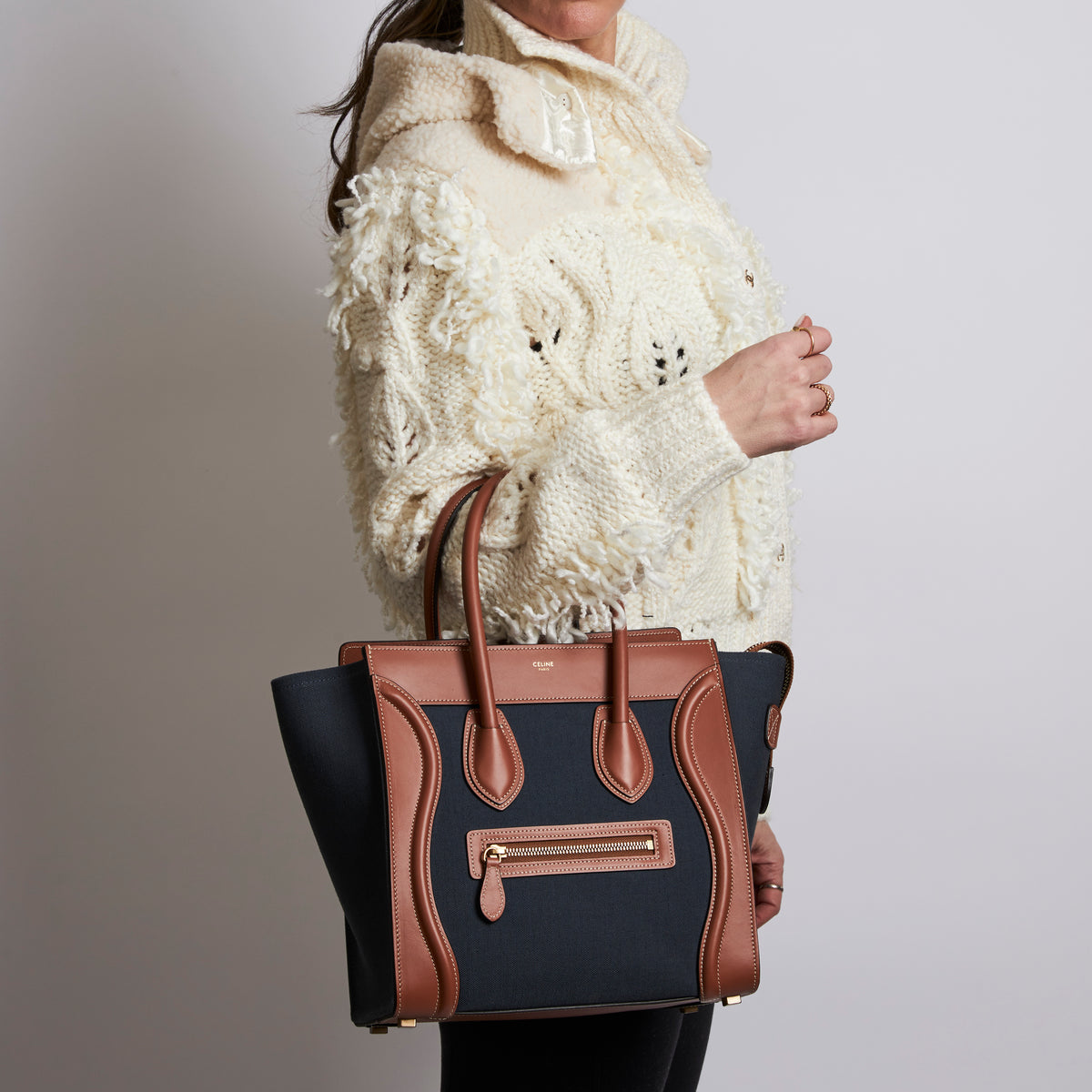 Excellent Pre-Loved Denim Top Handle Tote Bag with Brown Leather Details and Contrast Stitching. (on body)