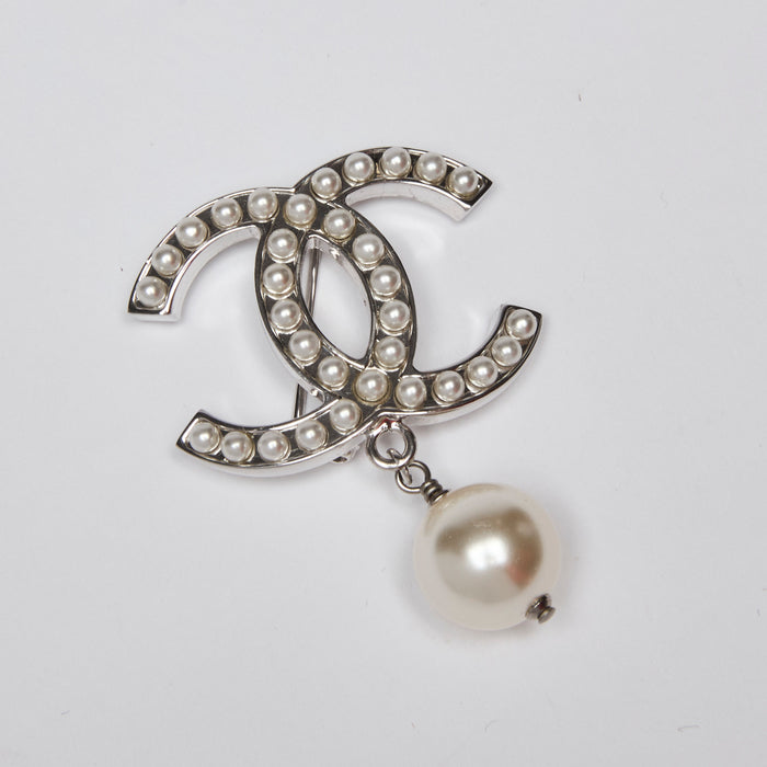 Excellent Pre-Loved Silver Tone Hardware Faux Mini Pearl Logo Brooch with Faux Pearl Drop. (front)