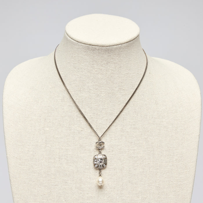 Pre-Loved Chanel™ Silver Tone Necklace with Crystal Embellished Square Pendant and Pearl Drop.