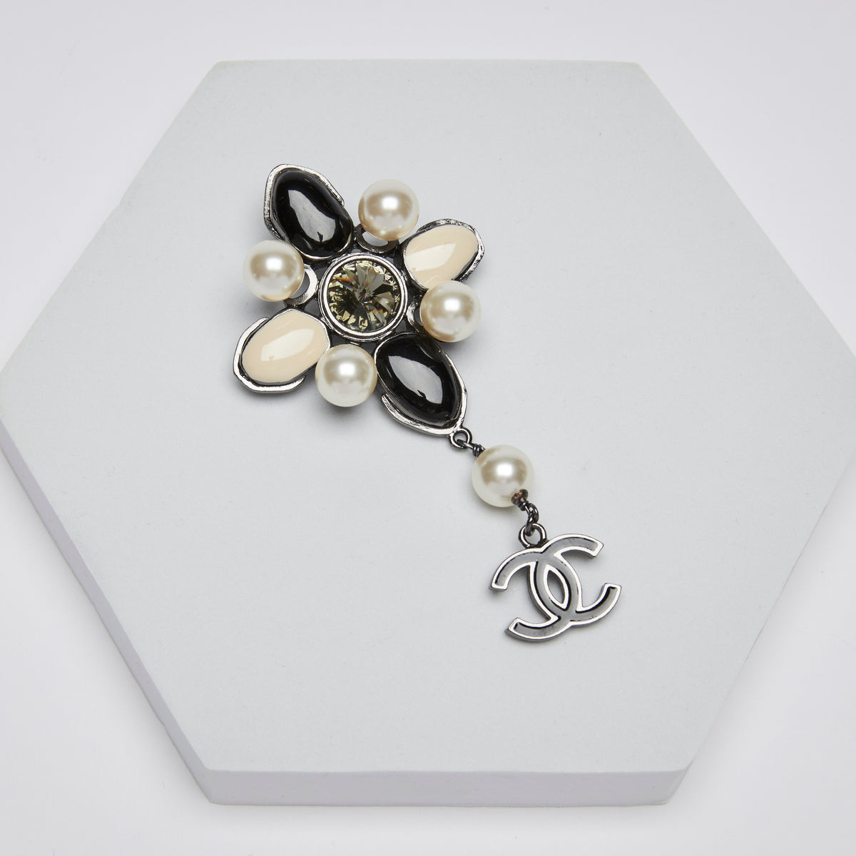 Excellent Pre-Loved Black/White Polished Stones and Glass Pearl Embellished Brooch with Dark Silver Tone Hardware and Black Enamel Logo Drop Pendant.  (front)