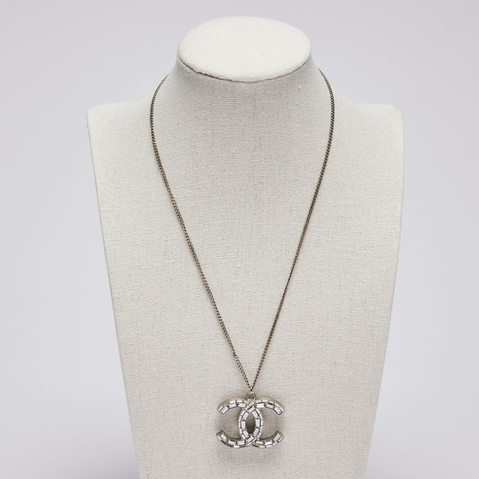 Excellent Pre-Loved Large Crystal Embellished Logo Pendant Necklace with Silver Tone Chain. (front)