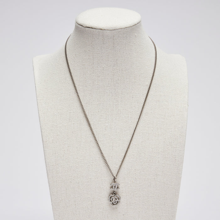 Excellent Pre-Loved Silver Tone Necklace with Crystal Embellished Logo and Camellia Drop Pendant.(front)