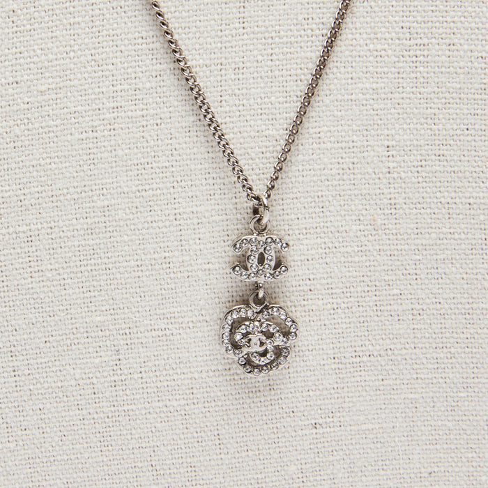 Excellent Pre-Loved Silver Tone Necklace with Crystal Embellished Logo and Camellia Drop Pendant.(close up)
