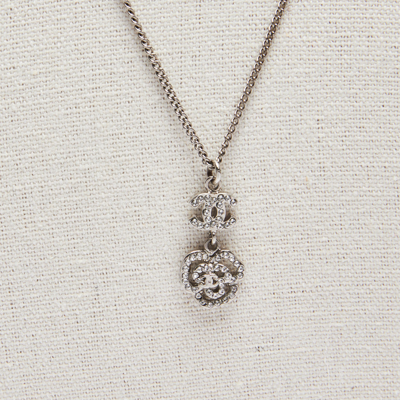 Excellent Pre-Loved Silver Tone Necklace with Crystal Embellished Logo and Camellia Drop Pendant.(close up)
