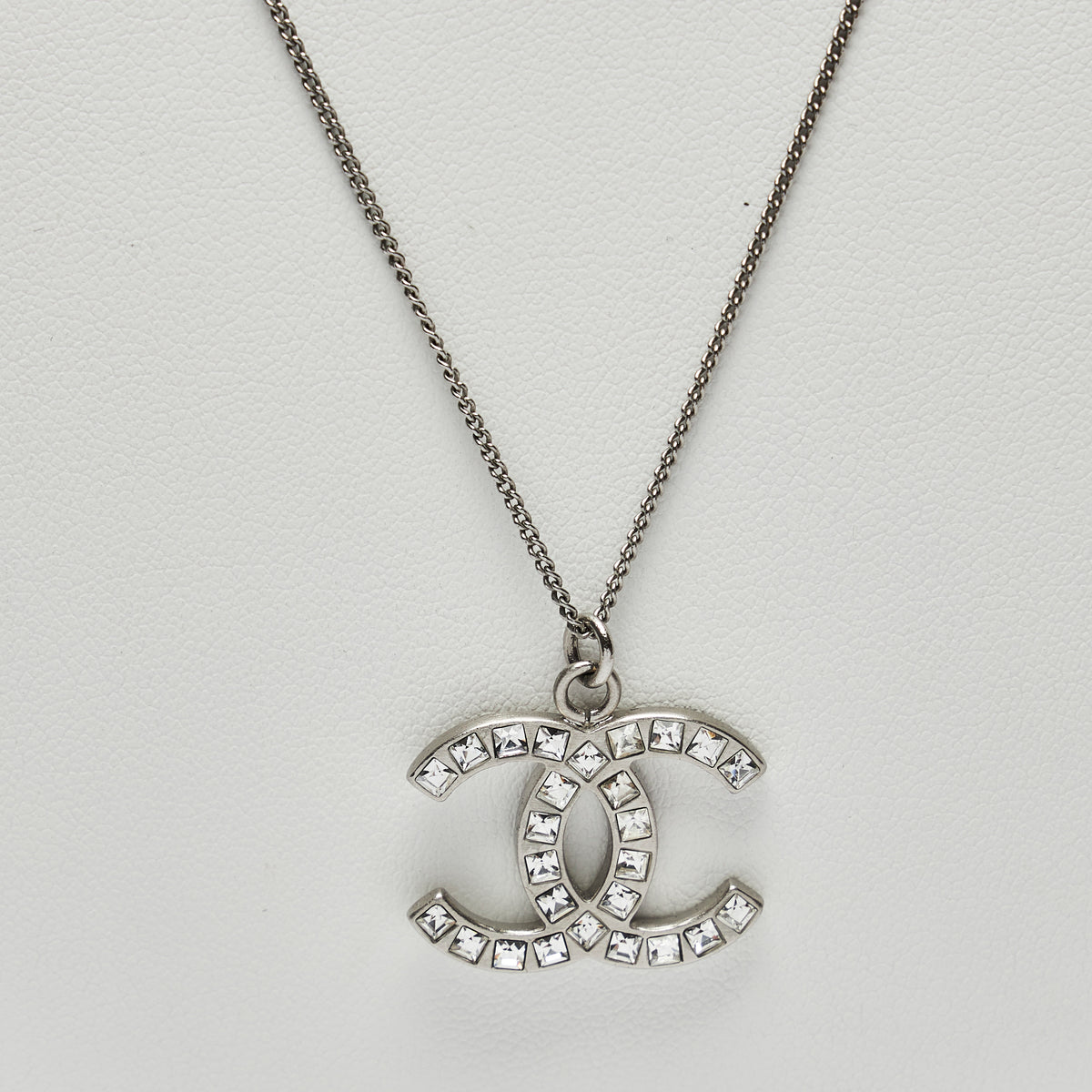 Excellent Pre-Loved Silver Tone Logo Pendant Necklace with Square Crystals Embellishment.(logo)