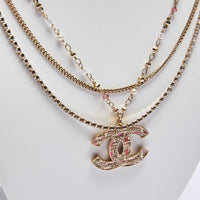 Excellent Pre-Loved Pink Enamel Gold Tone Tweed Textured Logo Pendant Multi-Strand Necklace with Mini Faux Pearls and Pink/White Crystals.(close up)
