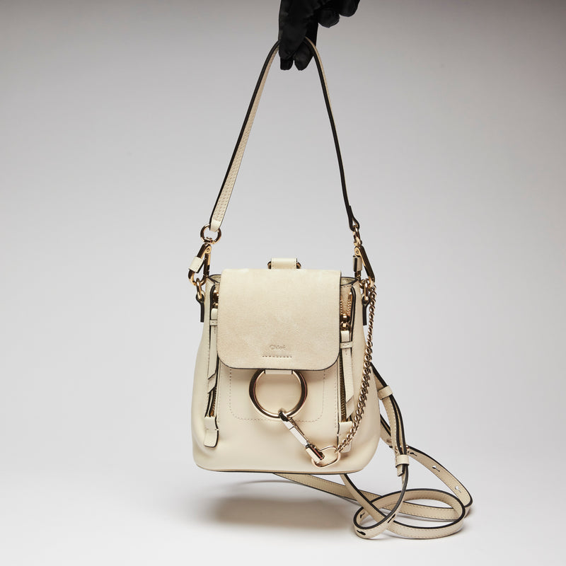Excellent Pre-Loved White Suede and Leather Mini Backpack with Light Gold Hardware.(holding)