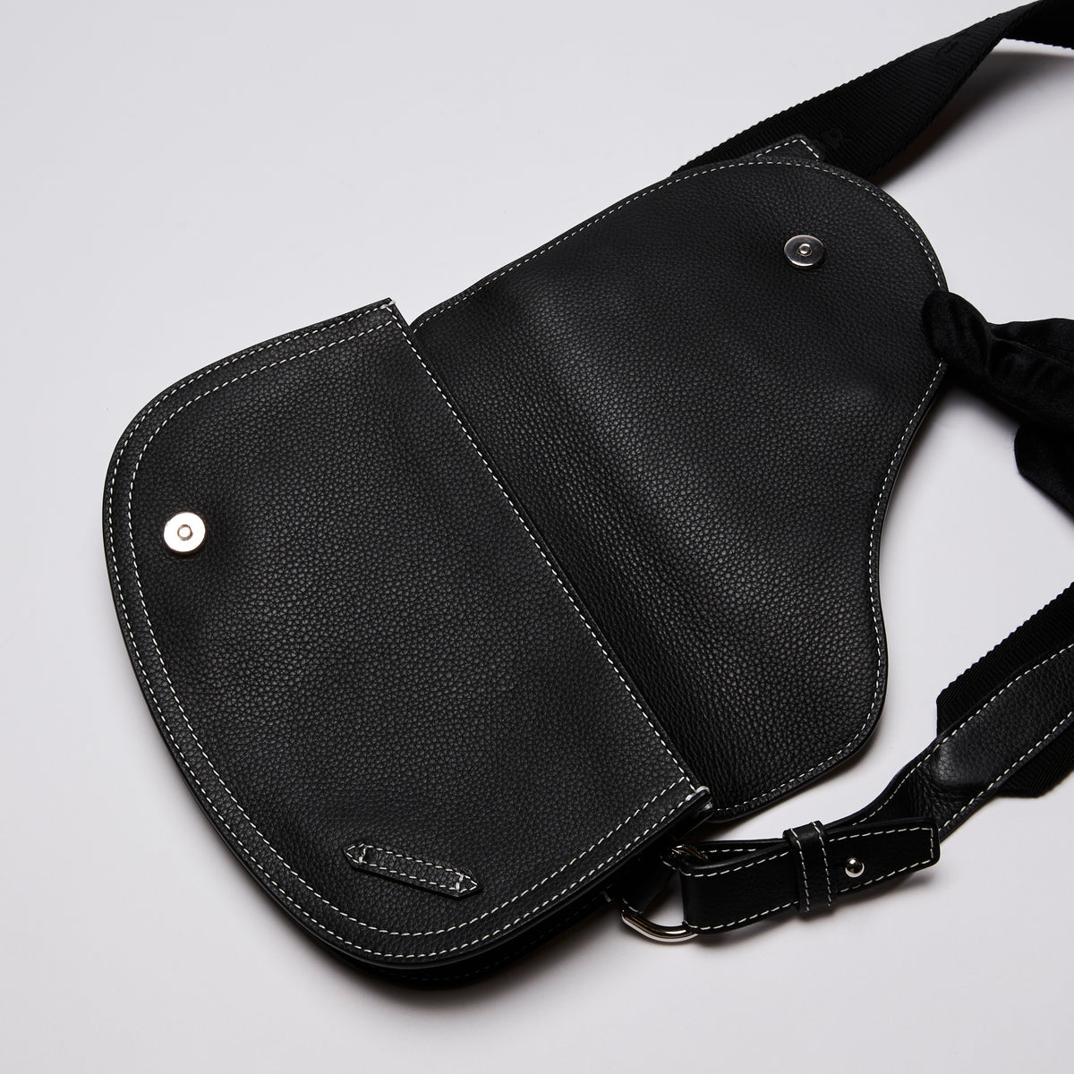 Dior X KAWS Small Black Pebbled Leather Saddle Bag with White Stitching Detail