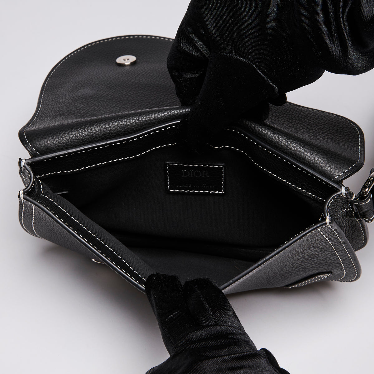 Dior X KAWS Small Black Pebbled Leather Saddle Bag with White Stitching Detail