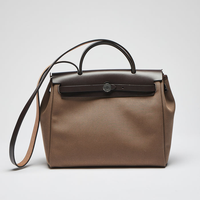 Excellent Pre-Loved Brown Canvas Top Handle Flap Bag with Shoulder Strap. (front)