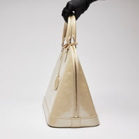 Pre-Loved Large Monogram Embossed Ivory Patent Leather Half Dome Shaped Top Handle Bag. (side)