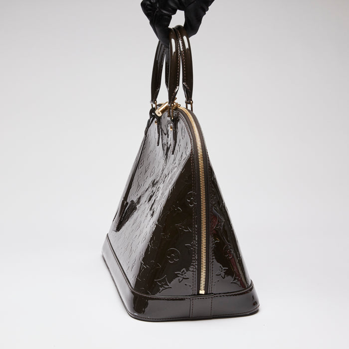 Pre-Loved Dark Plum Monogram Embossed Patent Leather Top Handle Bag.  (side)
