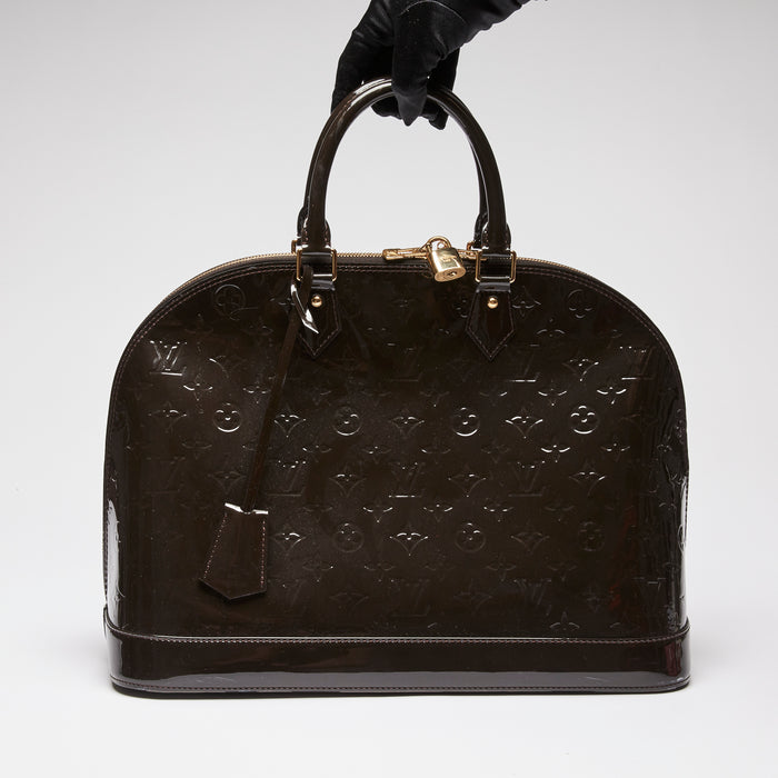 Pre-Loved Dark Plum Monogram Embossed Patent Leather Top Handle Bag.  (front)