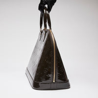 Pre-Loved Dark Plum Monogram Embossed Patent Leather Top Handle Bag. (side)