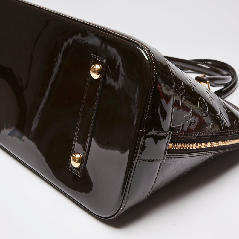 Pre-Loved Dark Plum Monogram Embossed Patent Leather Top Handle Bag. (corner)