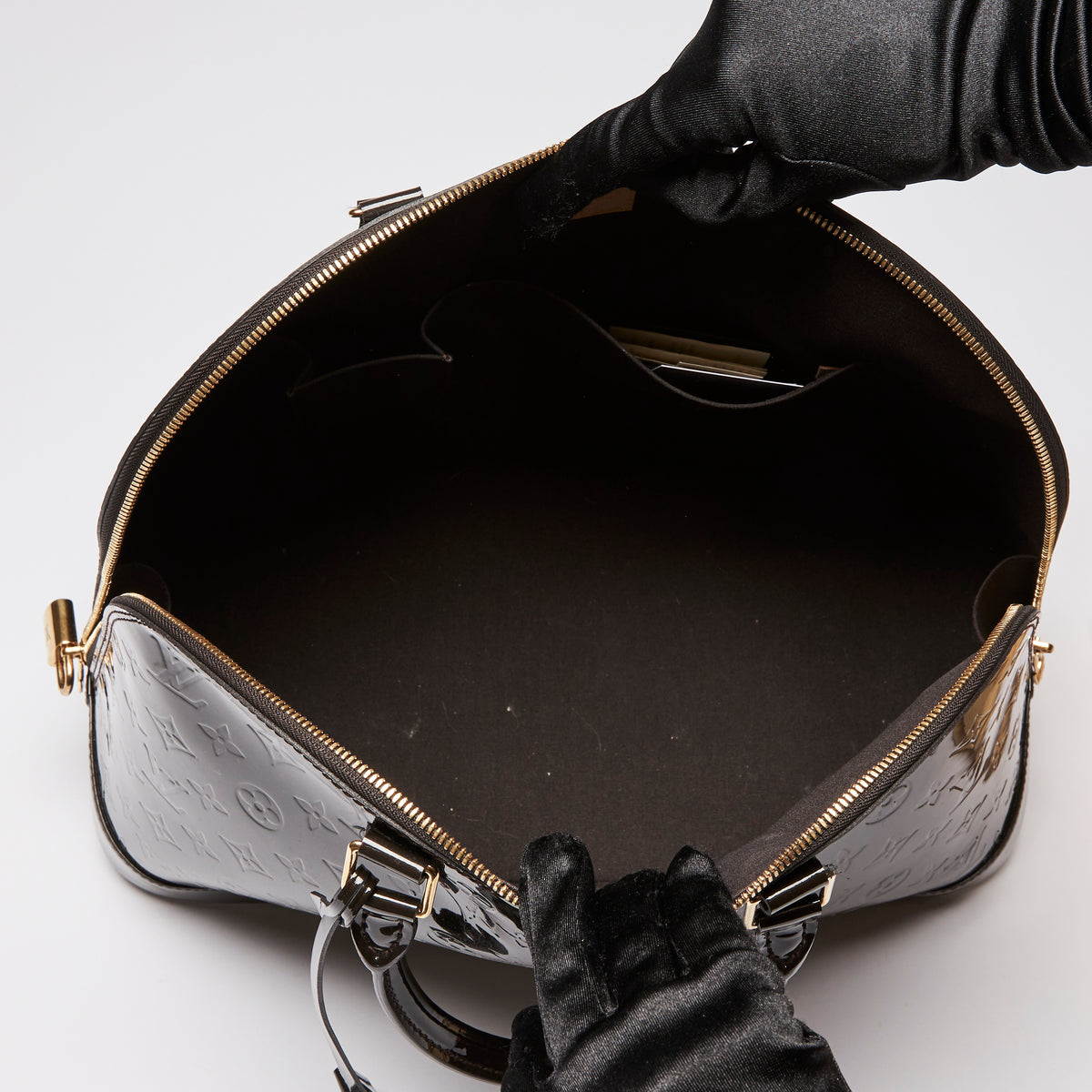 Pre-Loved Dark Plum Monogram Embossed Patent Leather Top Handle Bag. (interior)