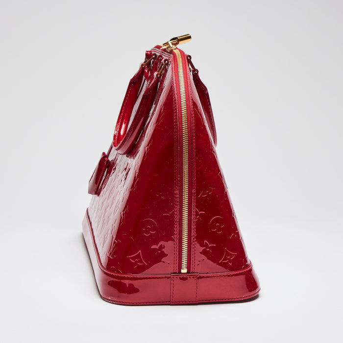 Pre-Loved Large Monogram Embossed Red Patent Leather Half Dome Shaped Top Handle Bag. (side)