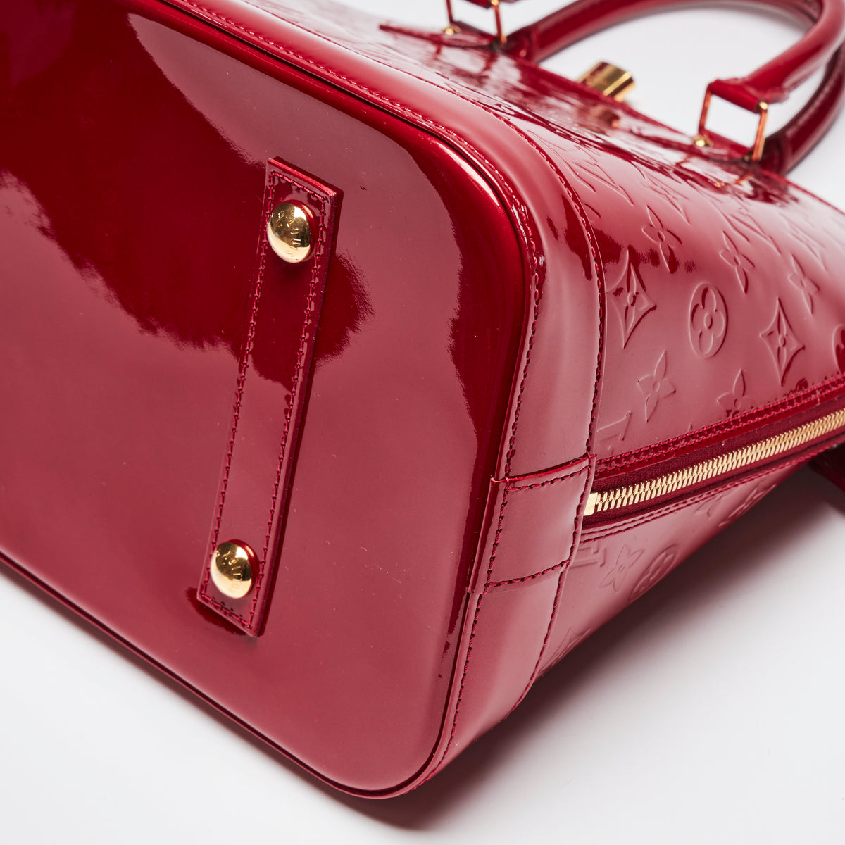 Pre-Loved Large Monogram Embossed Red Patent Leather Half Dome Shaped Top Handle Bag. (corner)