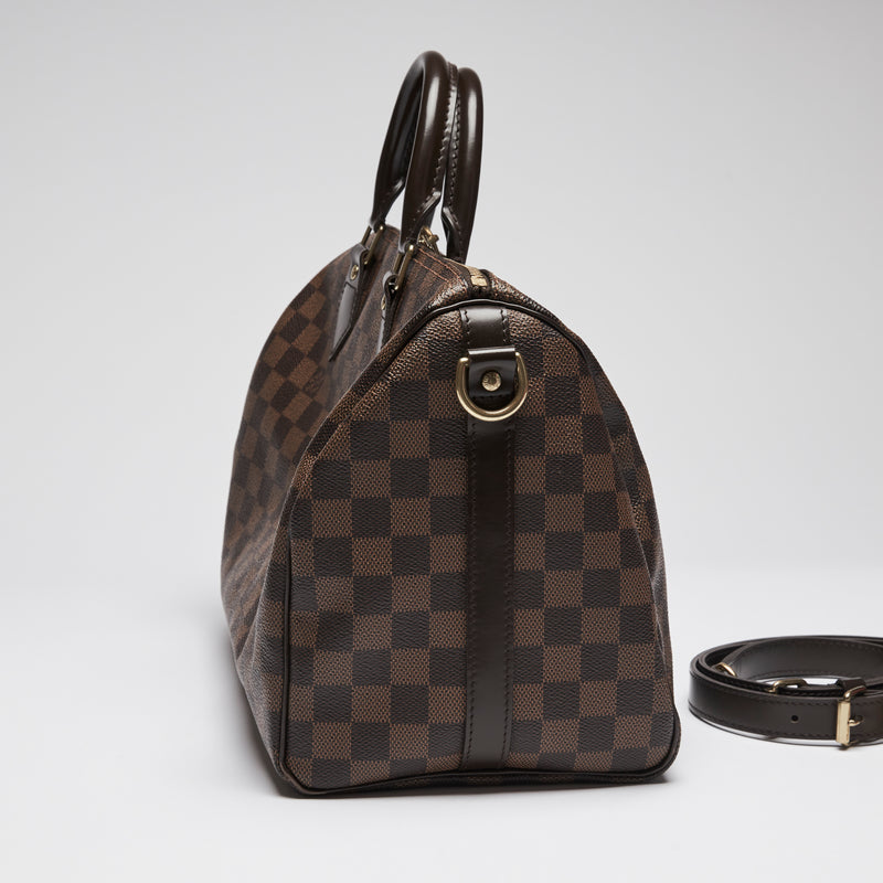 Excellent Pre-Loved Dark Brown Checker Patterned Coated Canvas Top Handle Bowling Bag with Top Zip and Dark Brown Leather Accents. (side)
