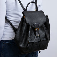 Excellent Pre-Loved Black Monogram Embossed Grained Leather Back Pack.(on body)