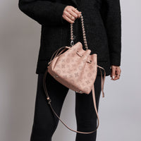 Excellent Pre-Loved Pink Perforated Monogram Leather Bucket Bag. (on body)