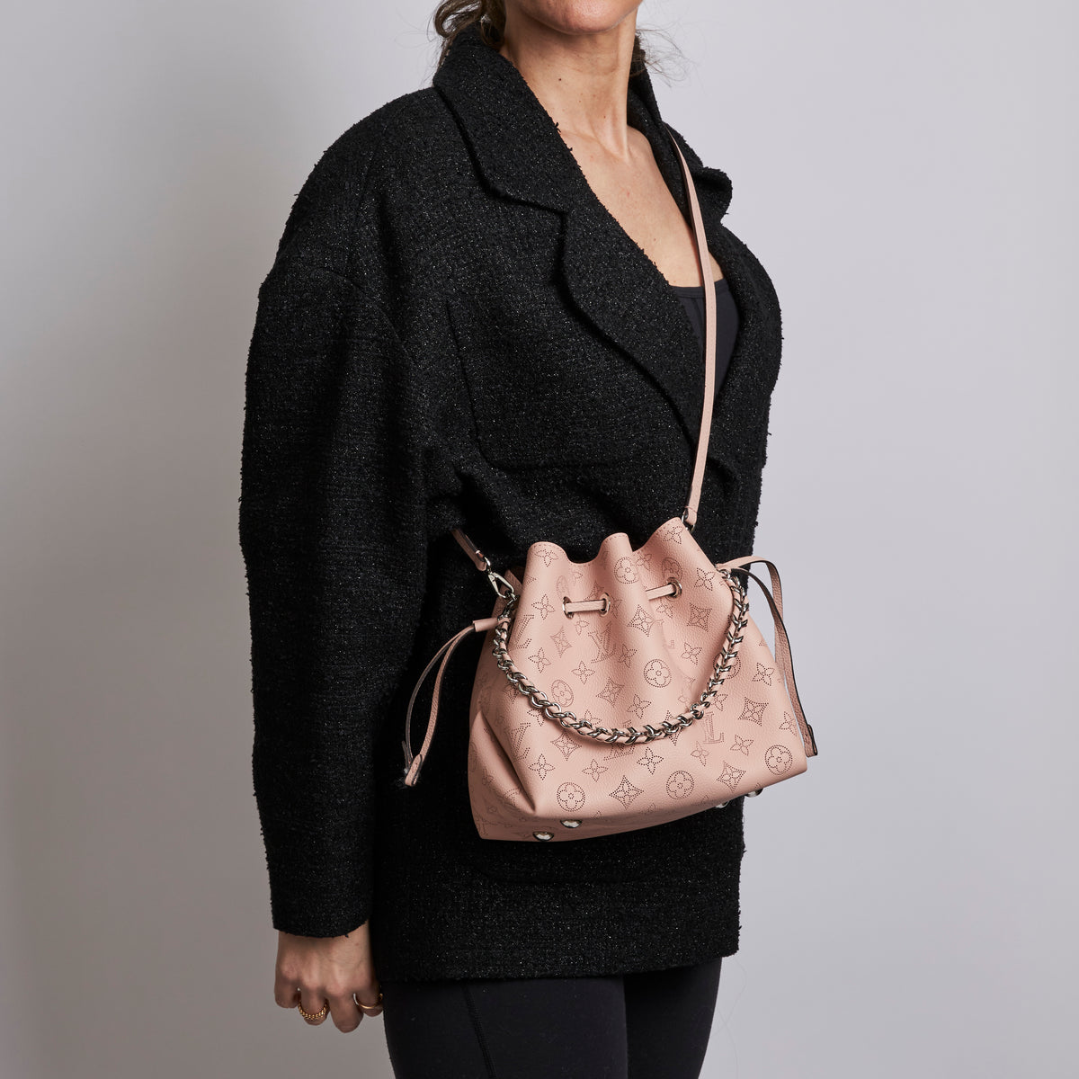 Excellent Pre-Loved Pink Perforated Monogram Leather Bucket Bag.  (on body)
