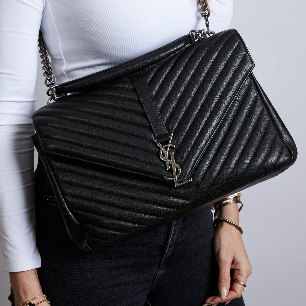 Pre-Loved Black Grained Leather Chevron Stitched Flap Bag with Removable Shoulder Chain and Handle.(on body)