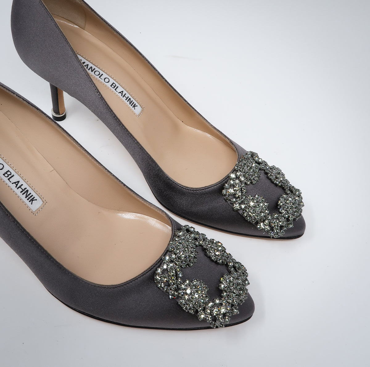 grey satin heels with dark silver buckle ornament (front view)