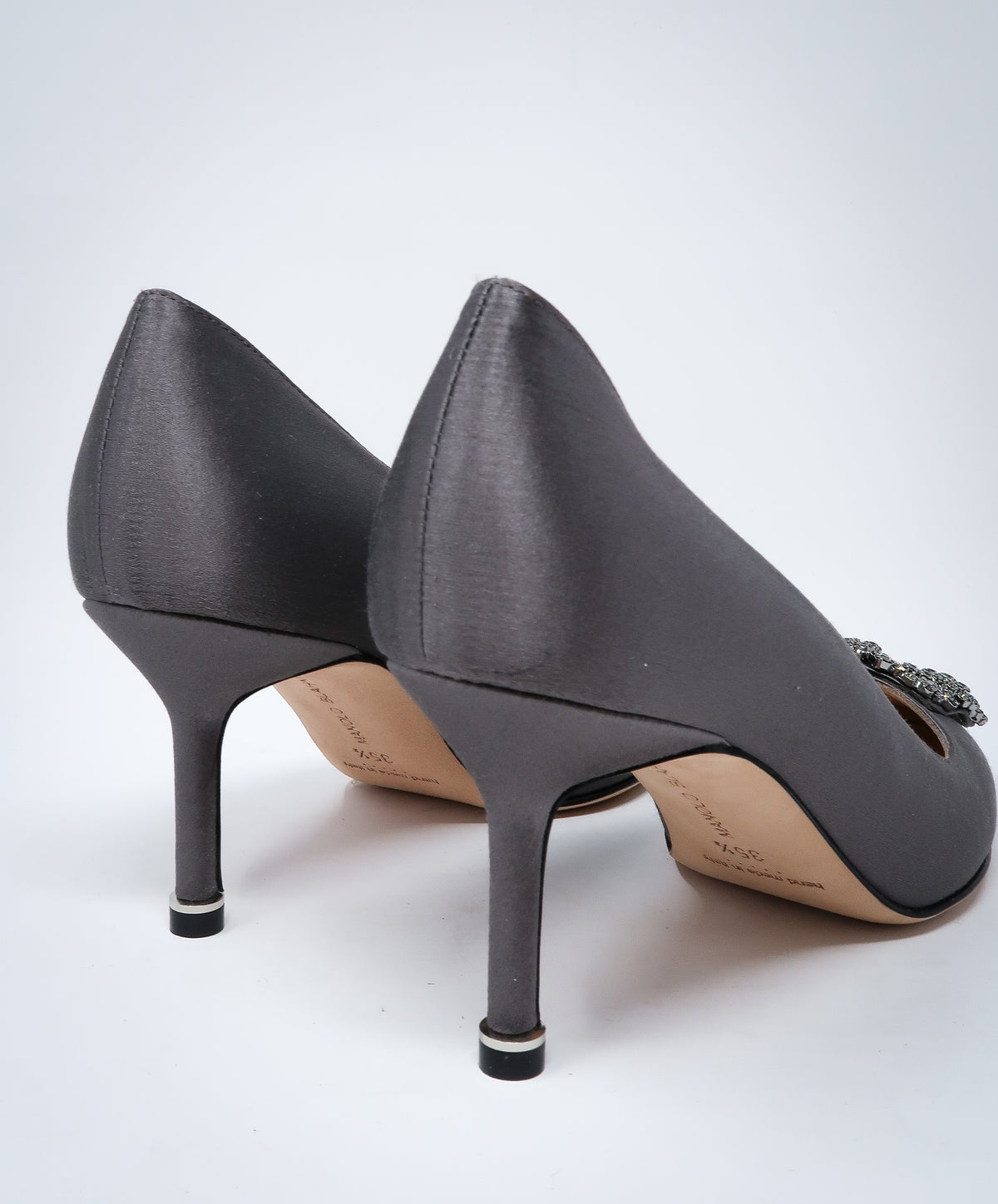 grey satin heels with dark silver buckle ornament (back view)