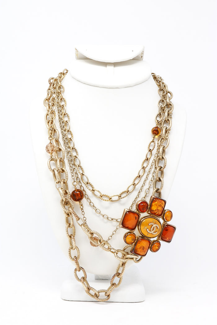 aged gold multichain necklace with orange resin ornament (front view)
