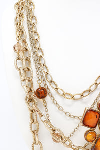 aged gold multichain necklace with orange resin ornament (detail view)
