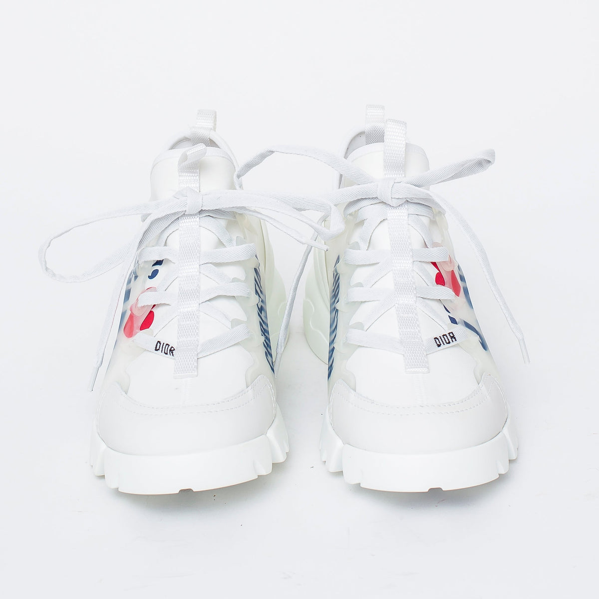 white fabric lace up sneakers with blue logo printed on side (front view)